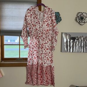 White dress with flower detail, lays right above ankles (I’m 5’2) long sleeve